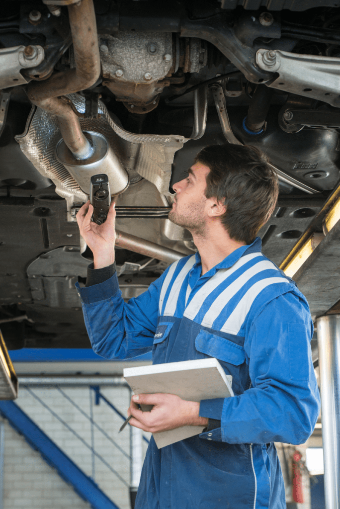 Mechanic inspecting underneath a vehicle - MOT and Servicing Bilston